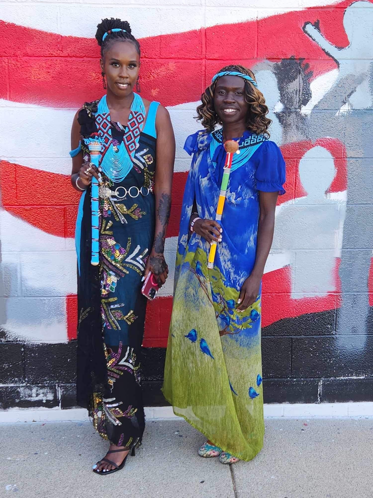 Two women by mural