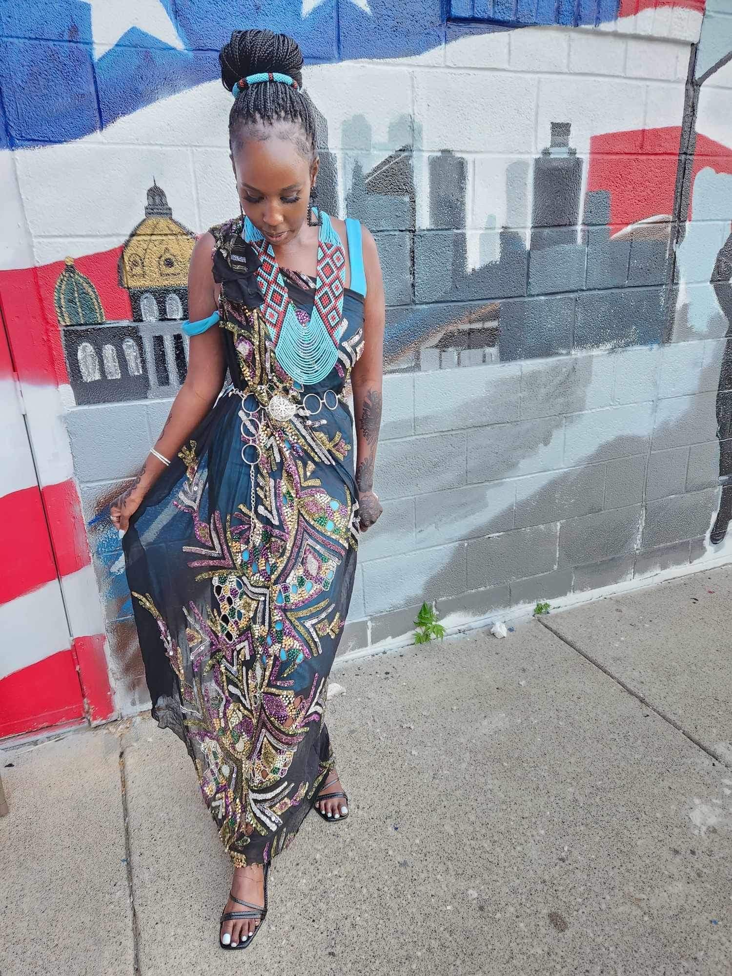 Woman by colorful mural